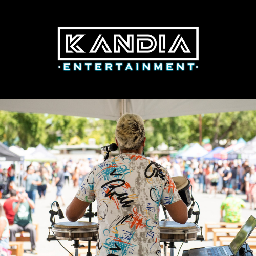 A musician with bleached hair in a graffiti-ed shirt faces away from the camera, facing a crowd. A logo above the musician reads "Kandia Entertainment"